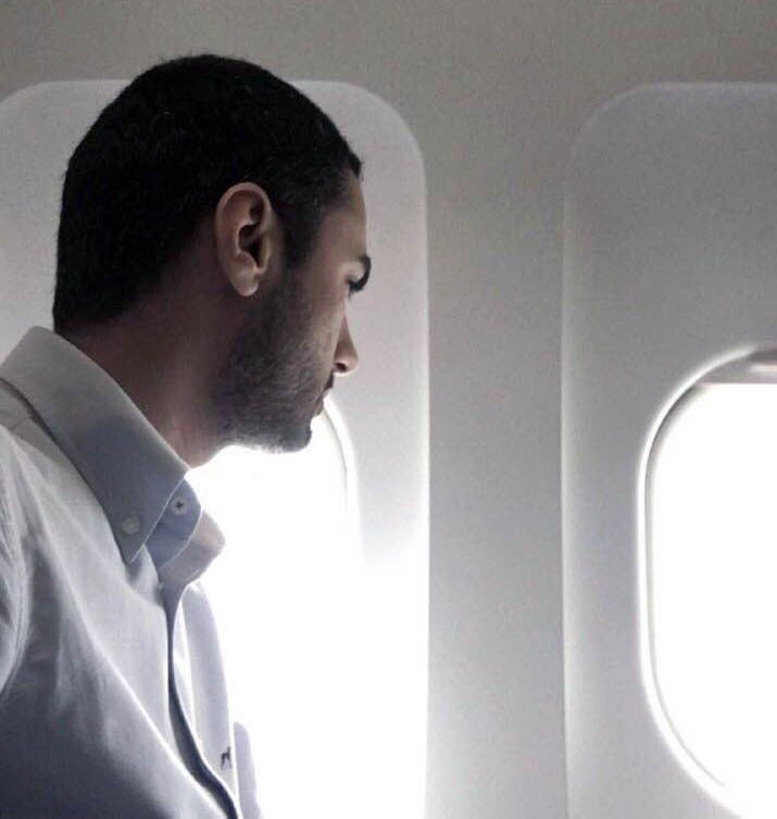 Farhad Pakan is looking outside of the airplane window